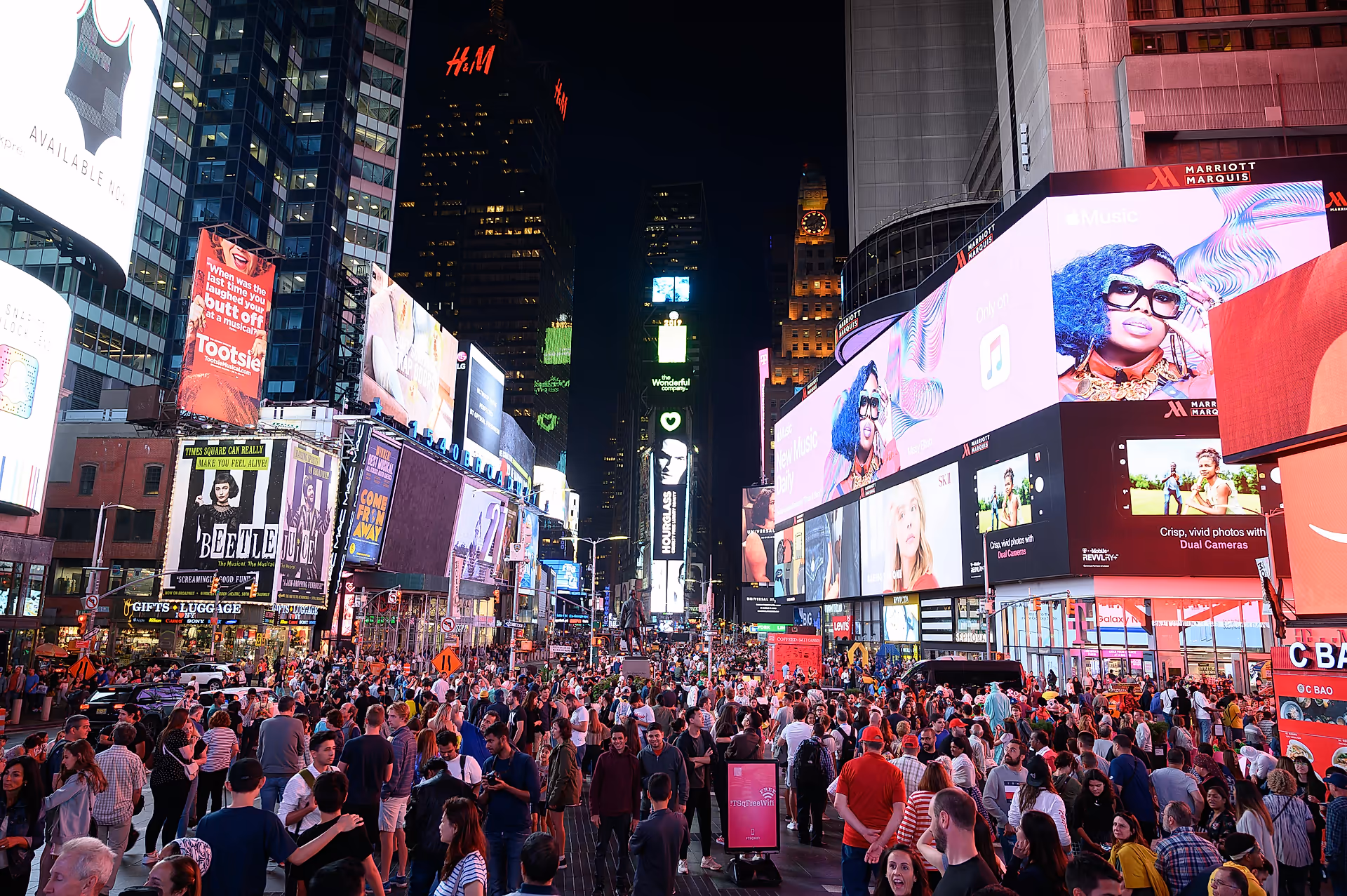 times square at night bustling with lights and people